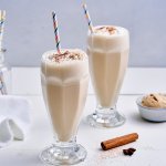 Op tafel staan twee grote glazen gevuld met milkshake, maar niet zomaar milkshake. Dit is er eentje met huisgemaakte chai latte en afgewerkt met slagroom en een snuifje kaneelpoeder. 