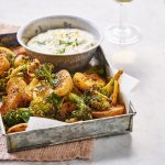 Er staat een ovenschaal op de tafel met hierin de geroosterde aardappelpartjes en broccoli. Het romig hummussausje serveren we apart in een kommetje.