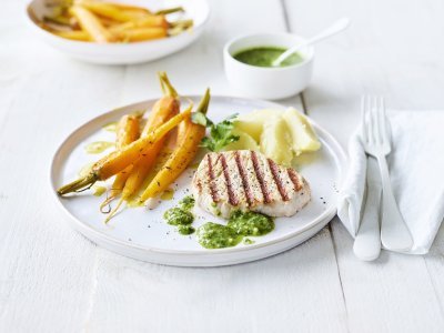 Gegrilde mignonnette met pesto van peterselie en Oud Brugge kaas Een mooi in streepjes gegegrild stukje varkensvlees ligt op een wit bord, geserveerd met gegaarde wortels en gekookte aardappelen. We serveren geen saus bij dit stukje vlees, maar homemade pesto van peterselie en Brugge kaas.
