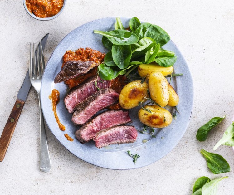 Gegrilde steak met romescosaus en gepofte krieltjes Gegrilde steak met romescosaus en gepofte krieltjes
